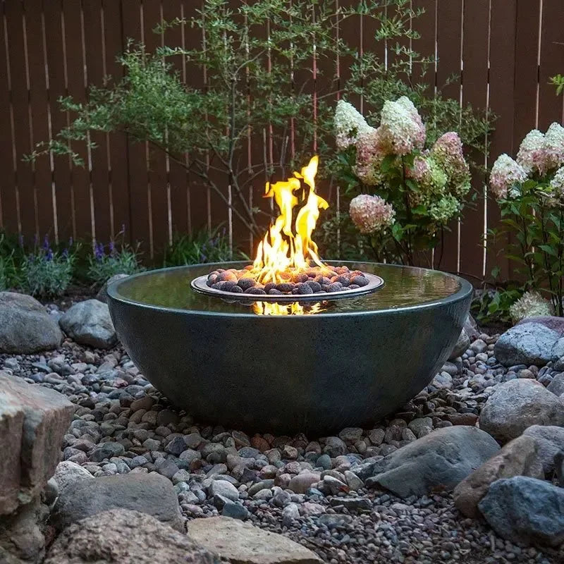 Aquascape Fire and Water Spillway Basin decorative feature with fire and water elements in a garden setting.